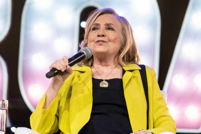 Person speaking into microphone wearing yellow jacket