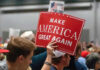 Person holding Make America Great Again sign