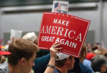 MAGA in Turmoil Over Trump’s Iran Offensive Person holding Make America Great Again sign