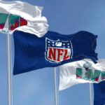 Four flags with NFL and Super Bowl LVII logos.