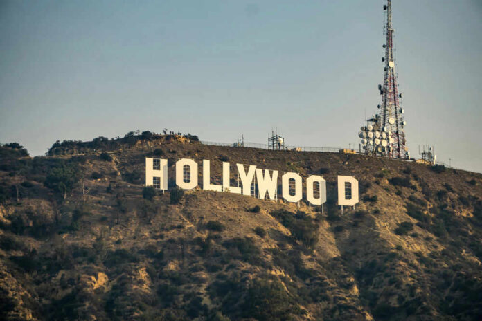 278156460 Hollywood sign with communication tower on hillside.