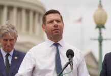 Congressman’s Spy Ties Under FBI Microscope Again A politician speaking at a press conference outside the Capitol building