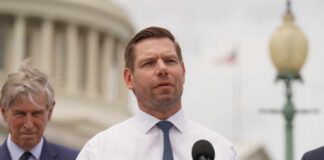 A politician speaking at a press conference outside the Capitol building