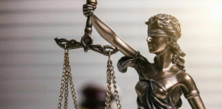 Blindfolded lady justice statue with scales and gavel