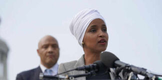 Woman speaking at a podium with microphones