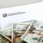 IRS letter with scattered U.S. dollar bills.