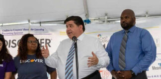 Three people speaking at a promotional event.