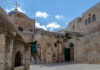 Historic religious site in Jerusalem with stone buildings and a cross