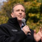 EPA Administrator SLAMS Biden’s Failed $159M Bus Project A man speaking into a microphone at an outdoor event