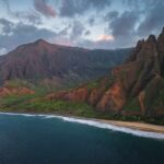Helicopter Crash at Hawaii’s Remote Beach Aerial view of a rugged coastline with mountains and ocean waves