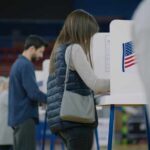 Voter ID Battle Heats Up as States Act Independently A person casting their vote at a polling station