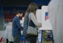 Voter ID Battle Heats Up as States Act Independently A person casting their vote at a polling station