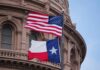American and Texas flags flying in front of a government building