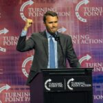 Speaker at a podium delivering a political speech