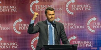 Speaker at a podium delivering a political speech