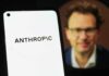 Military’s AI Dilemma — Vendor Blacklisted! Close-up of a smartphone displaying the word 'ANTHROPIC' with a blurred portrait in the background