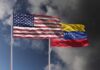 Diplomatic Reset: What’s the Real Agenda? Flags of the United States and Venezuela waving against a cloudy sky