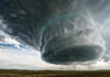 Massive storm cloud over open field sky threatening