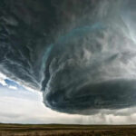 Massive storm cloud over open field sky threatening