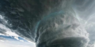 Massive storm cloud over open field sky threatening