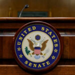 One “No” Vote TORCHES Career United States Senate emblem on wooden podium