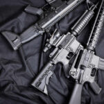 Black rifles on a dark fabric background