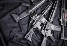 Black rifles on a dark fabric background