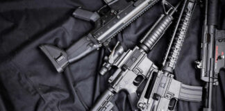 Black rifles on a dark fabric background