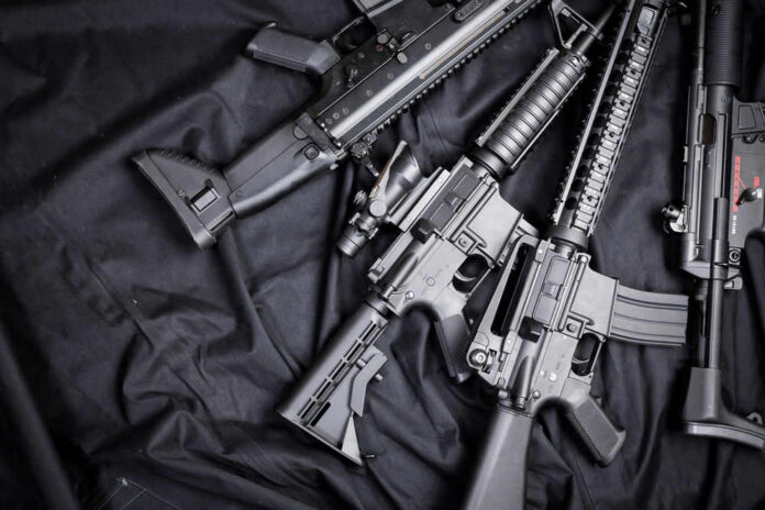 Black rifles on a dark fabric background