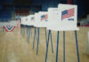 States Revolt: Trump’s Election Move Sparks Legal War Voting booths lined up in a gymnasium.