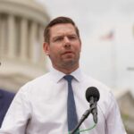 A politician speaking at a press conference outside the Capitol building