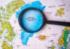 Magnifying glass over map of Greenland and Arctic Ocean