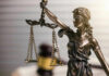 Blindfolded lady justice statue with scales and gavel