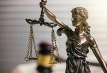 Blindfolded lady justice statue with scales and gavel