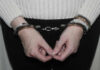 Person in handcuffs wearing a sweater