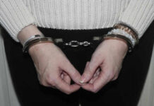 Person in handcuffs wearing a sweater