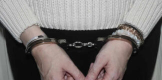 Person in handcuffs wearing a sweater