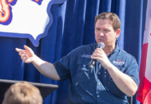 Person speaking into microphone during public event
