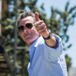 Man giving a thumbs up while wearing sunglasses