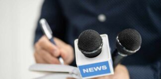 A journalist holding a notebook and microphones labeled 'NEWS'