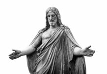 A statue of a figure with outstretched arms, representing a religious theme