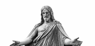 A statue of a figure with outstretched arms, representing a religious theme