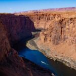 A scenic view of a canyon with a river flowing through it