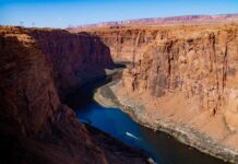 A scenic view of a canyon with a river flowing through it