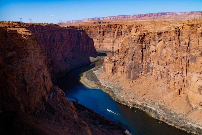 A scenic view of a canyon with a river flowing through it