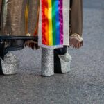 Close-up of glittery high heels and colorful fabric at a pride event