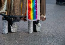 Close-up of glittery high heels and colorful fabric at a pride event