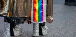 Close-up of glittery high heels and colorful fabric at a pride event