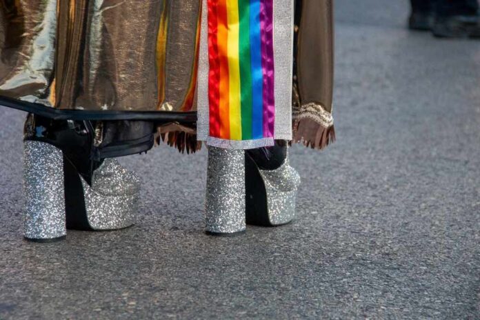 Close-up of glittery high heels and colorful fabric at a pride event