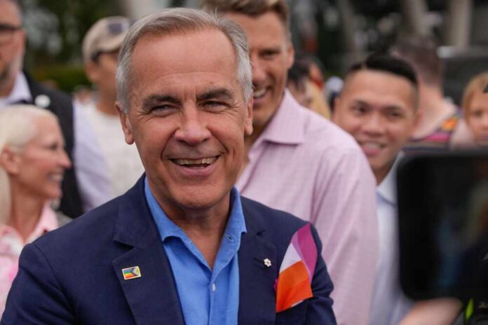 A smiling man in a blue suit surrounded by a diverse crowd at an outdoor event
